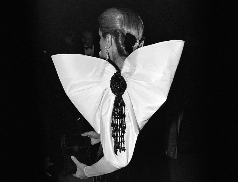 Carolina Herrera wearing iconic bow detail at a fashion event